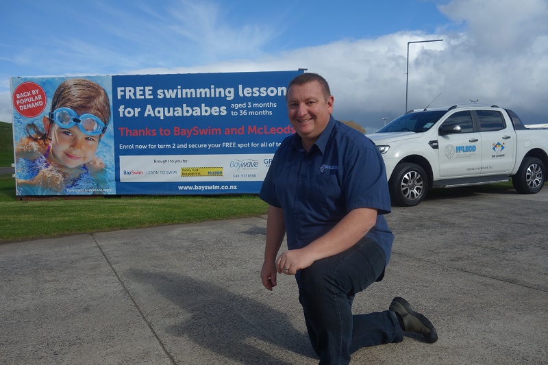 Scott Mcleod in front of an Aquababes promo banner